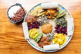 Goorsha signature dishes Doro Wot (spicy chicken stew), Tibs (sautéed meat), Vegetarian Combination Platter, Kitfo (minced raw beef)